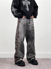 A knife-shaped blood-stained scratch mark on a pair of denim jeans