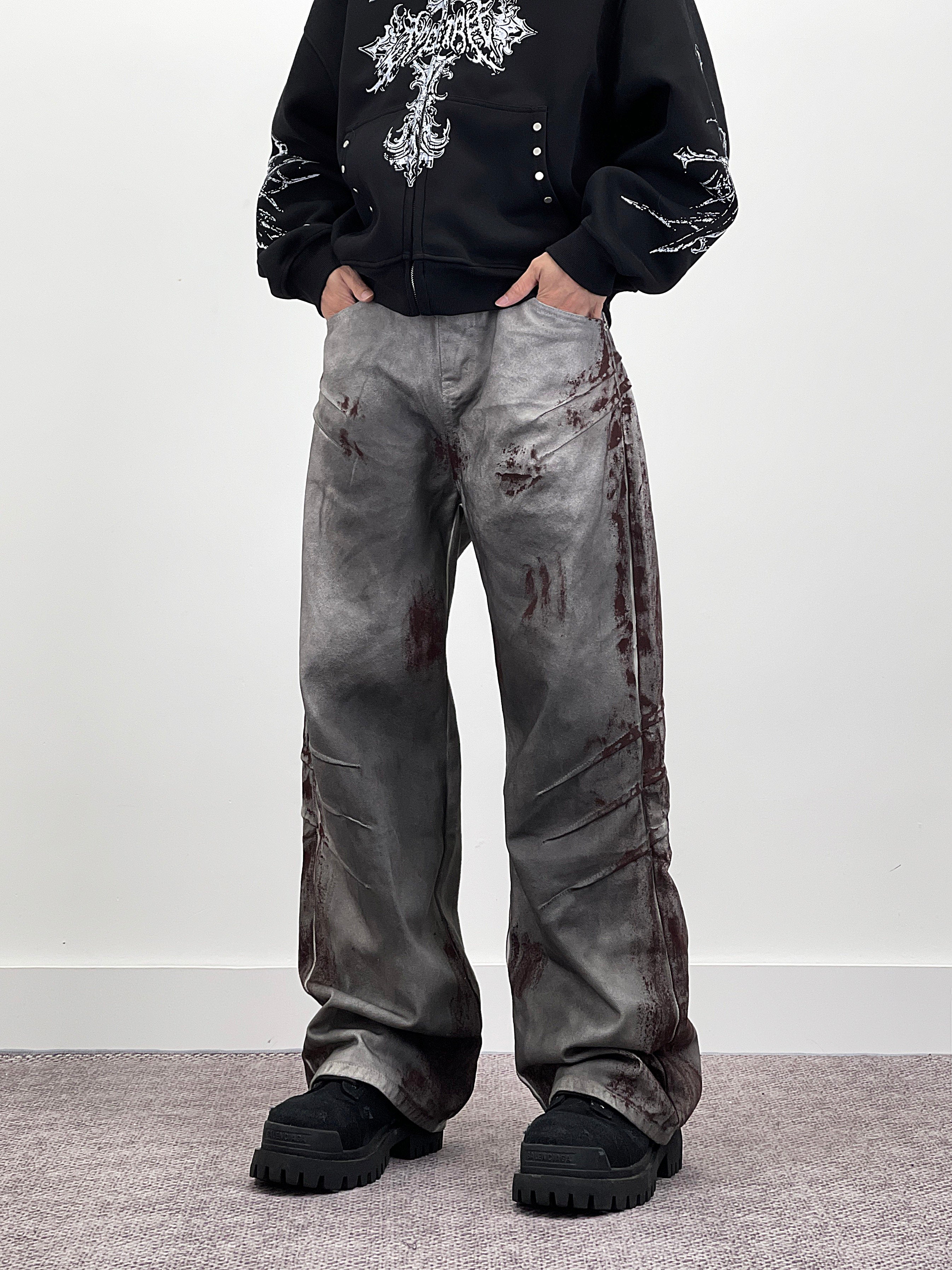 A knife-shaped blood-stained scratch mark on a pair of denim jeans
