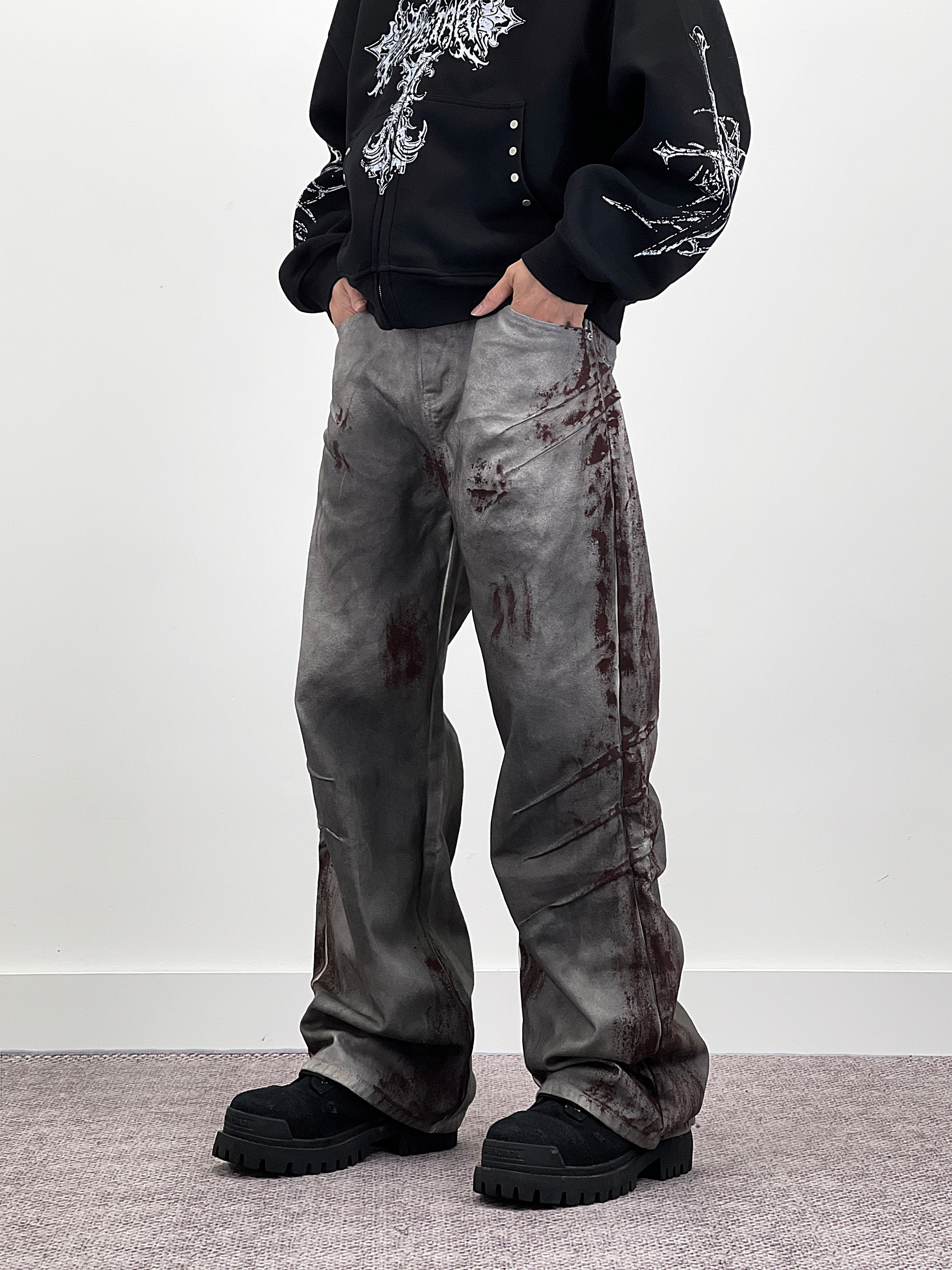 A knife-shaped blood-stained scratch mark on a pair of denim jeans