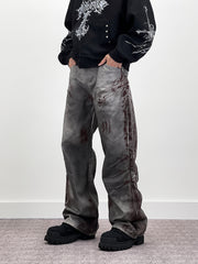 A knife-shaped blood-stained scratch mark on a pair of denim jeans