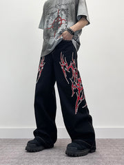 A knife flame embroidered wide-leg jeans