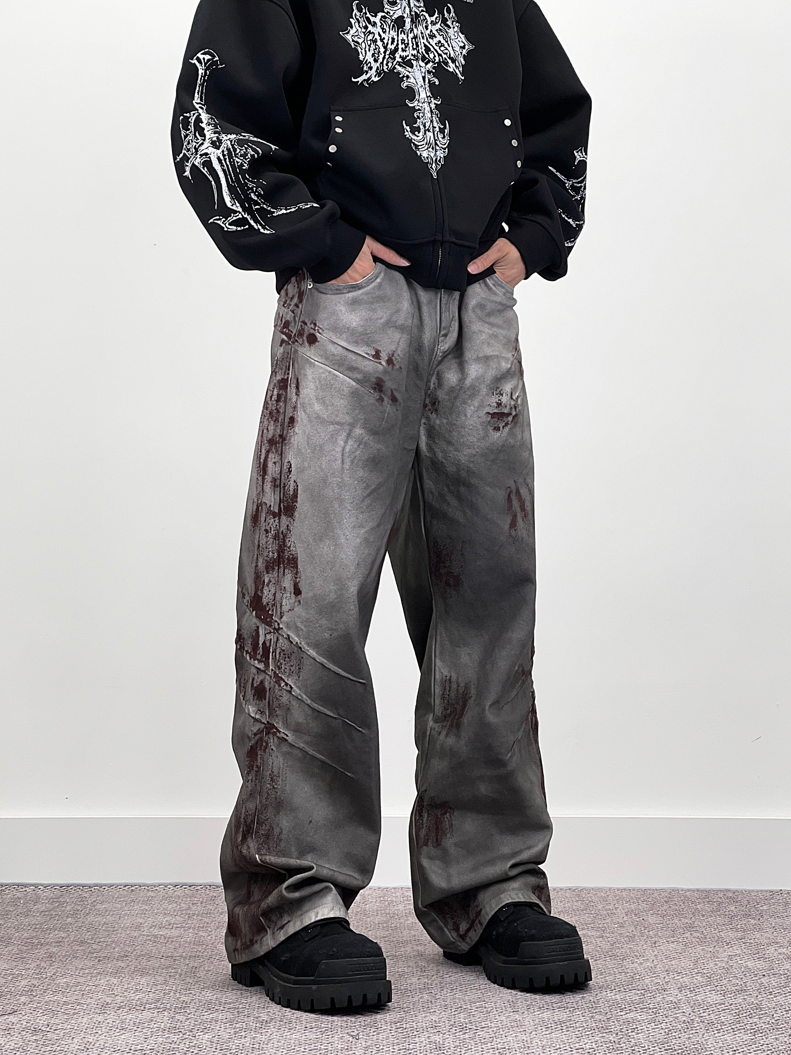 A knife-shaped blood-stained scratch mark on a pair of denim jeans
