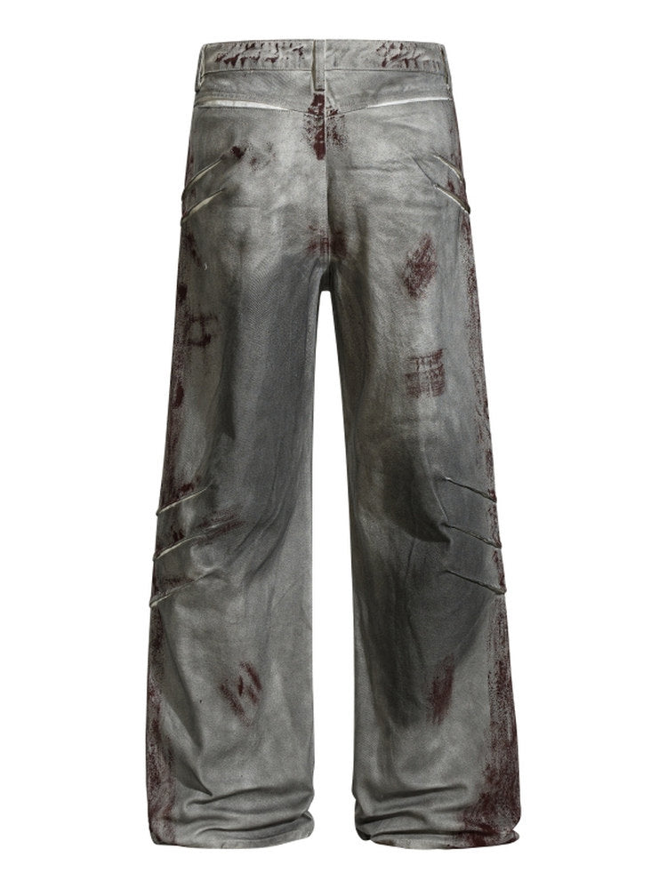 A knife-shaped blood-stained scratch mark on a pair of denim jeans